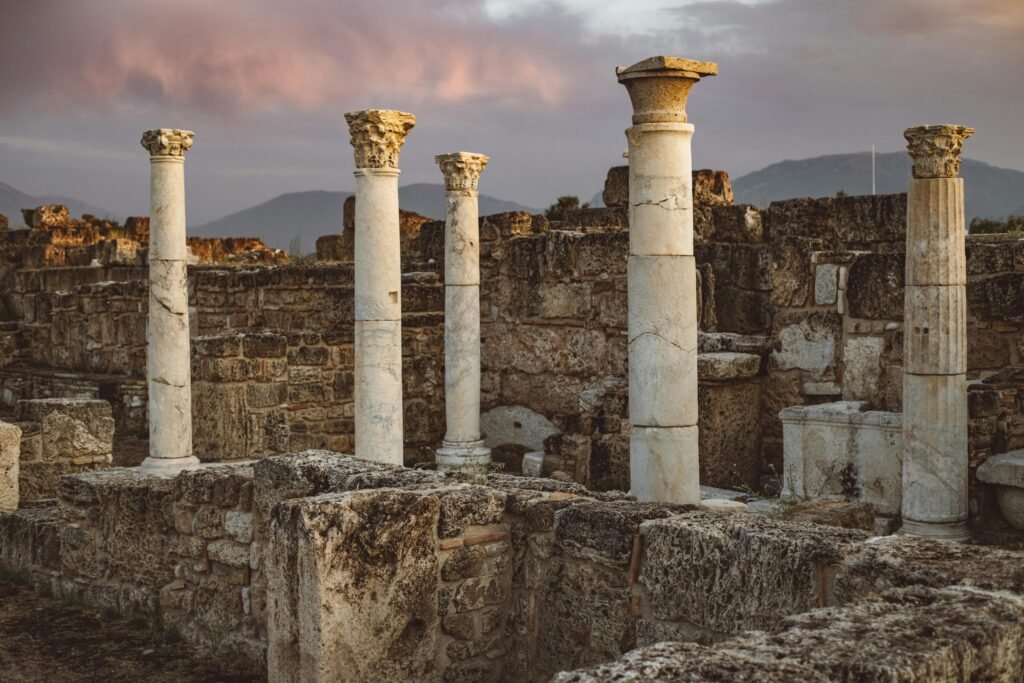 Explore the mesmerizing ancient ruins and columns against a scenic sunrise in Pamukkale, Turkey.